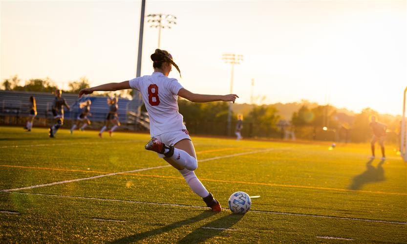 A soccer player prepares to kick the ball
